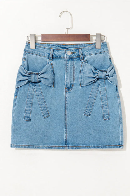 Medium-length acid wash high waist denim skirt with bowknot details, stylish and trendy for casual and chic outfits.