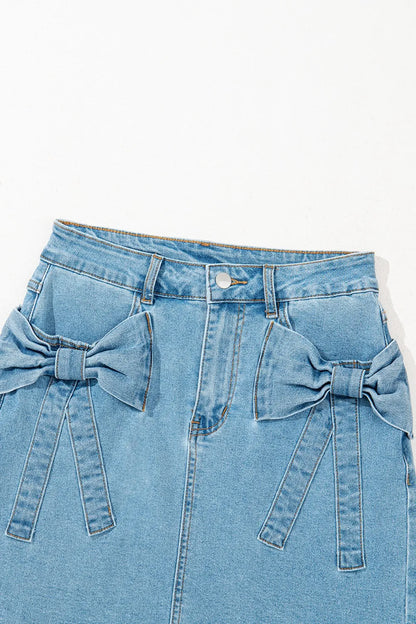 Light blue acid wash high waist denim skirt with bowknot details and a fitted silhouette, perfect for casual and trendy outfits.