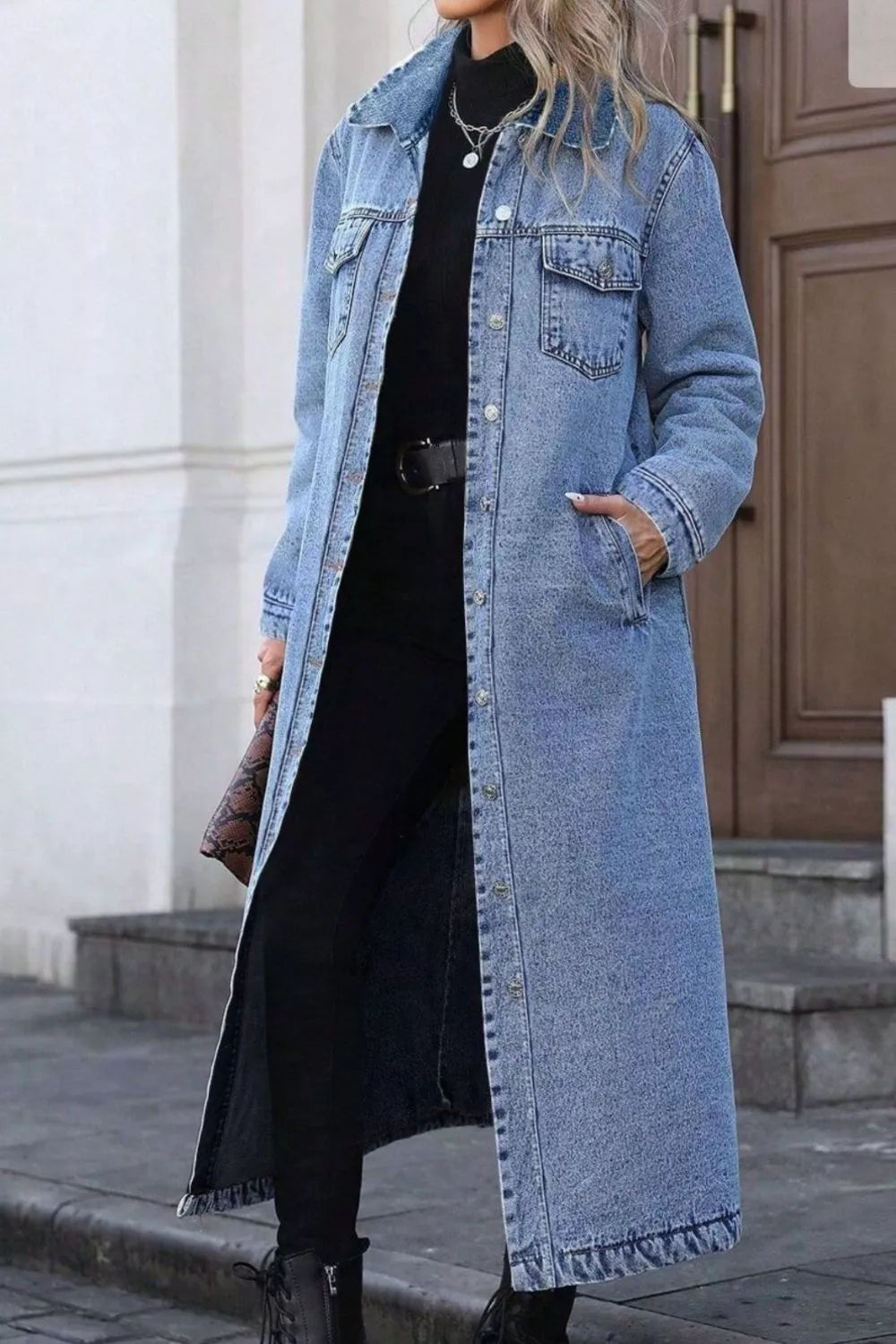 Longline button-front denim jacket by Trendsi, featuring classic blue denim, collar, and chest pockets, styled on a hanger.