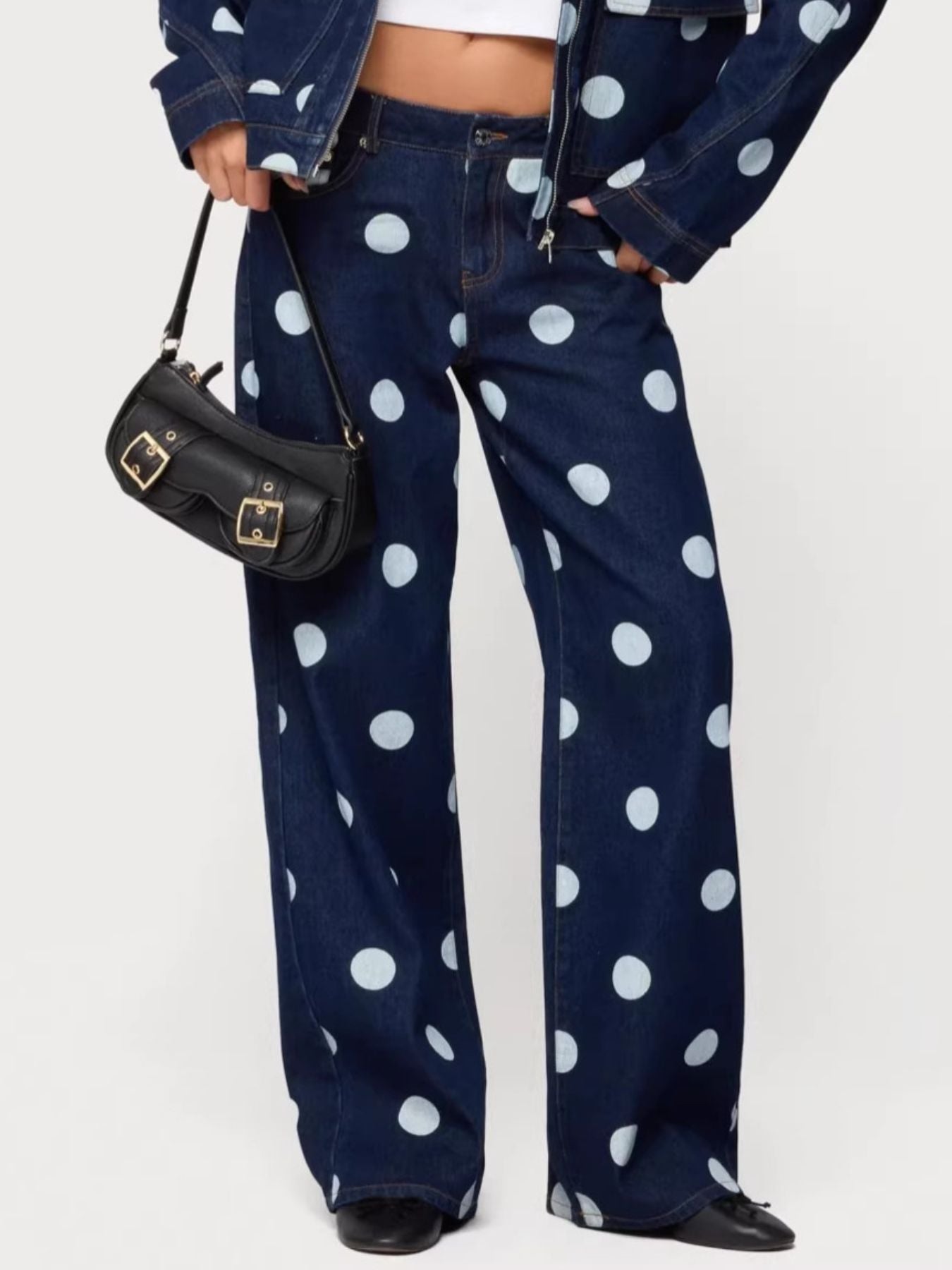 Medium shot of Trendsi polka dot wide leg jeans with a high waist and relaxed fit, showcasing the fabric pattern and leg style.