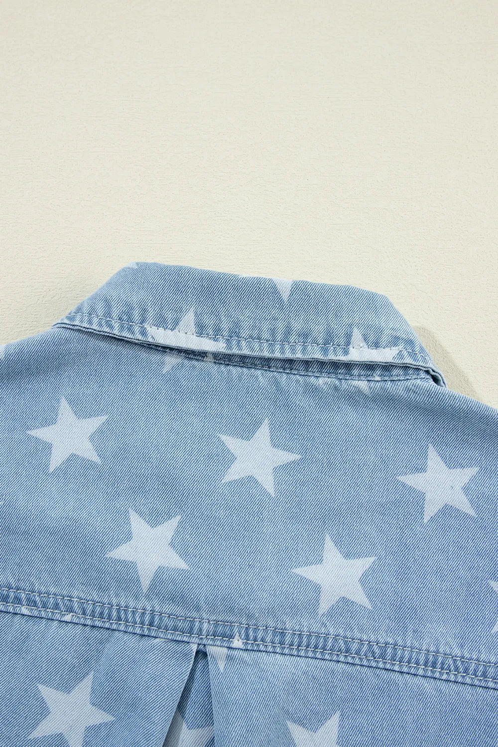 Medium denim top with raw hem, star collar detail, from Trendsi, featuring long sleeves and stylish casual design.