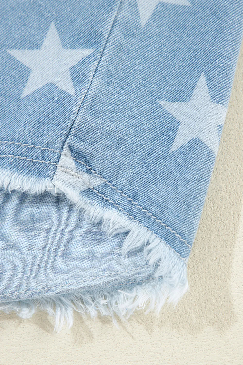 Raw hem star-embellished denim top with a collared neckline, featuring a trendy casual style from Trendsi.