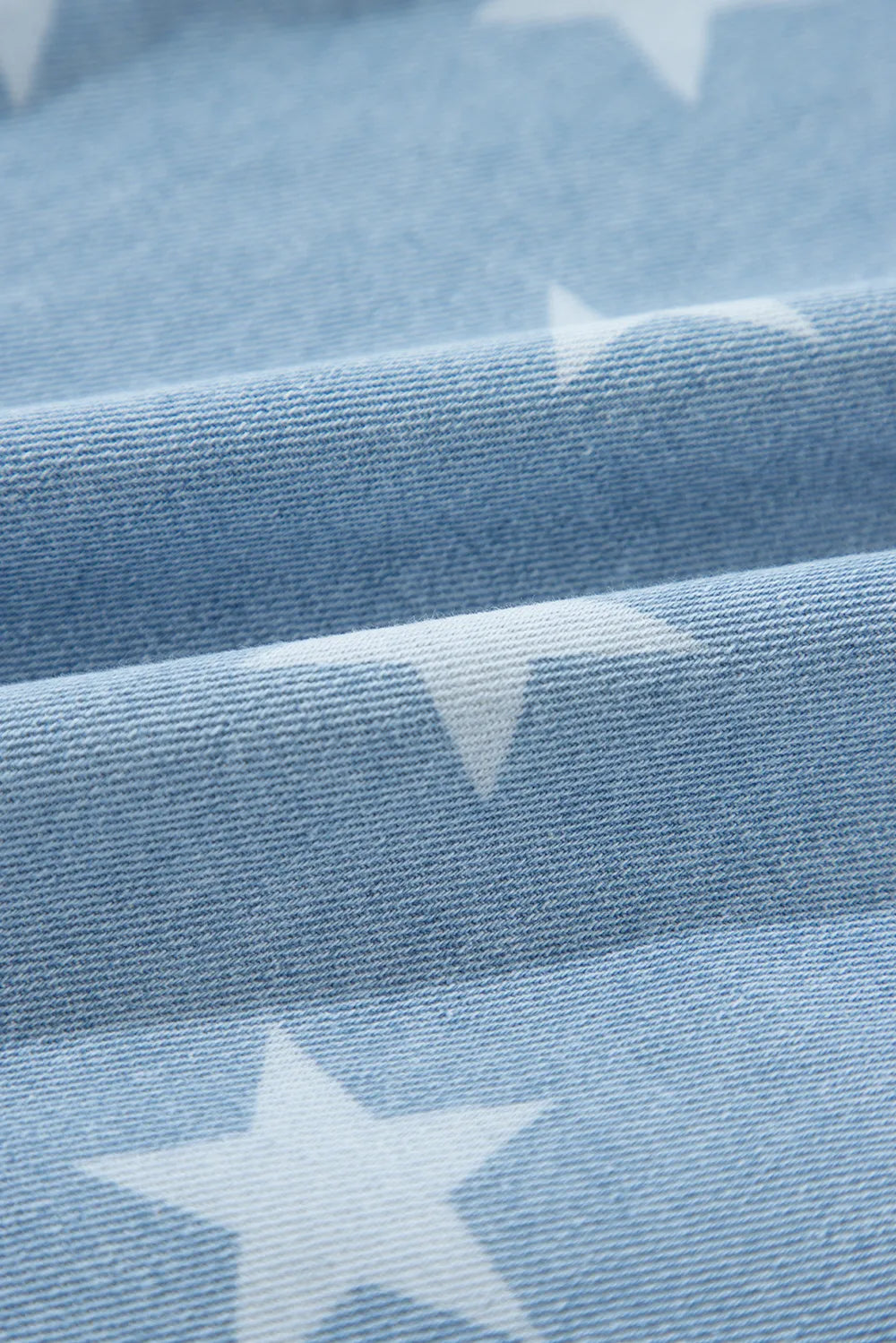 Raw hem star-embellished denim top with a collared neck from Trendsi, featuring a casual, stylish design in medium wash denim.