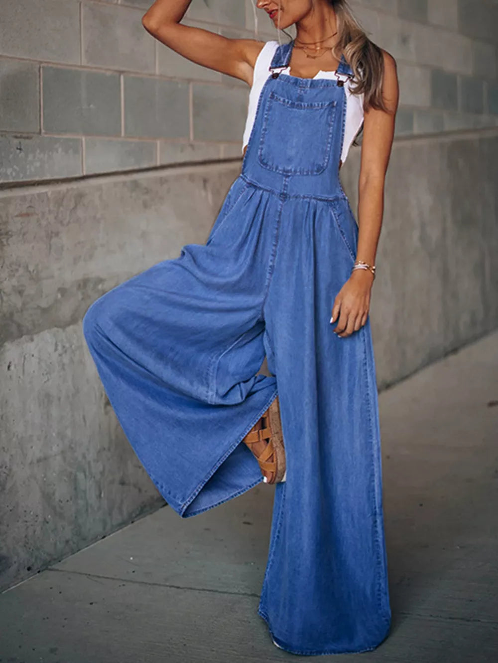 Medium shot of Trendsi wide-leg denim overalls featuring adjustable straps, front pockets, and a relaxed fit.