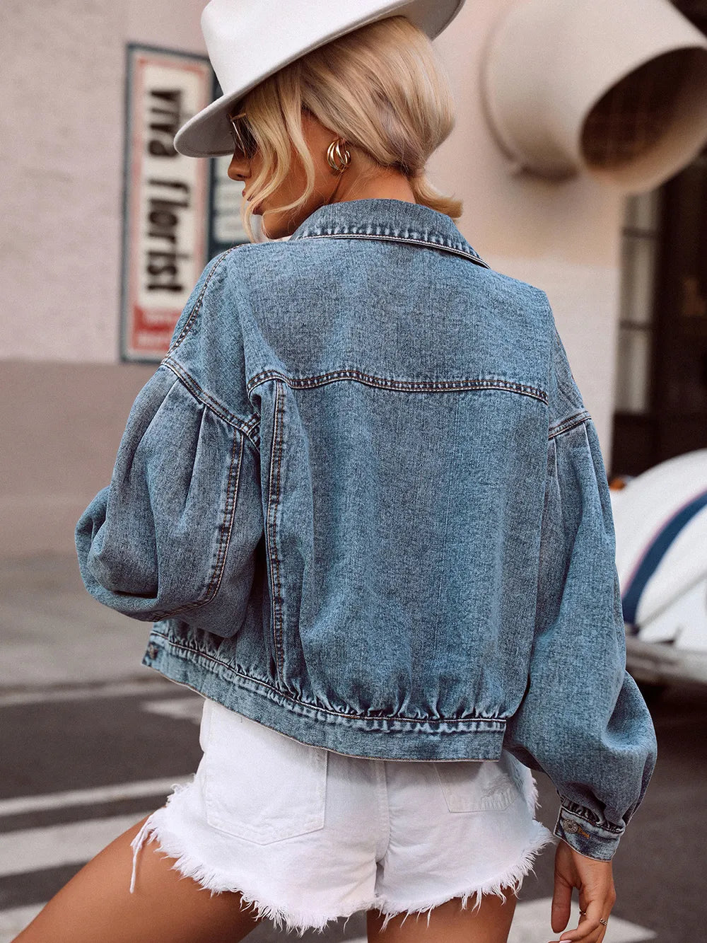 Medium-sized denim top with a collared neck and dropped shoulder design by Trendsi, featuring a stylish casual look.