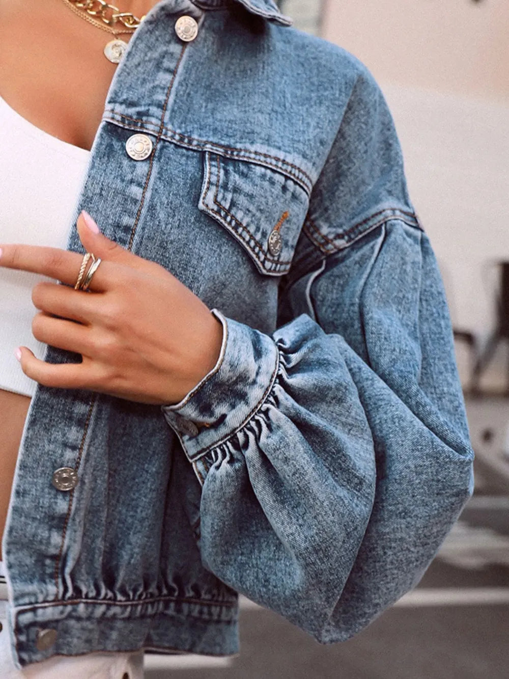 Medium-sized denim top with a collared neck and dropped shoulder design, featuring a trendy casual look.
