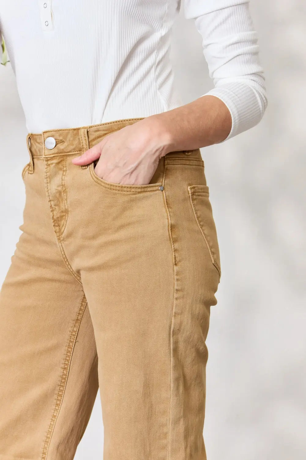 Risen full size fringe hem wide leg jeans from Trendsi, featuring a relaxed fit with stylish fringe detail at the hem.