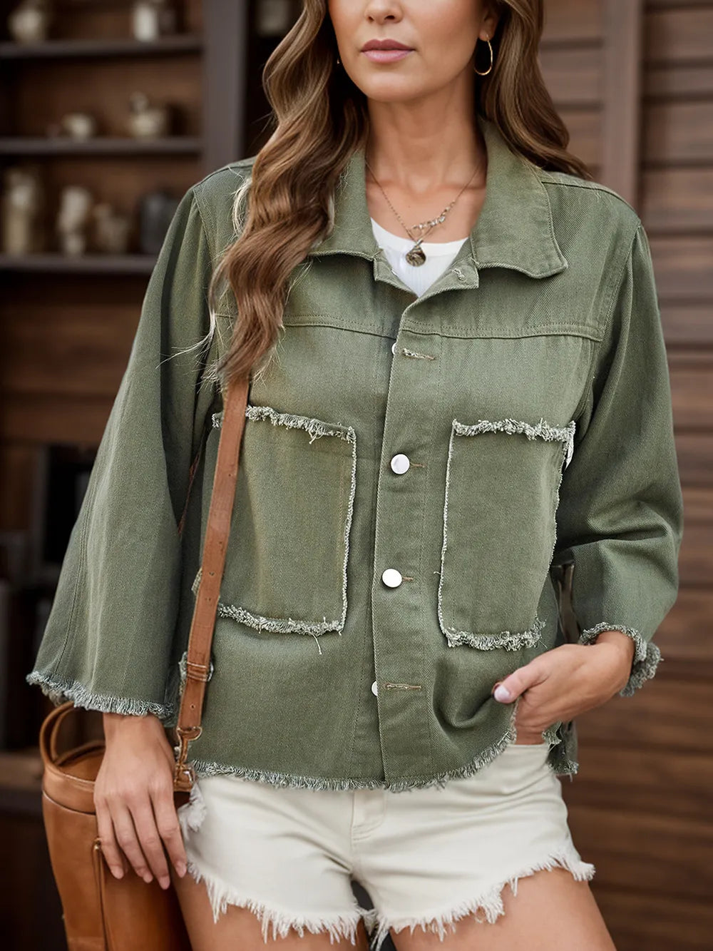 Raw hem button-up denim jacket by Trendsi featuring classic blue denim, front buttons, and a casual, stylish fit.