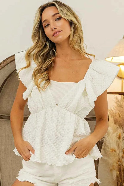 Crinkle bubble textured ruffled top by Trendsi featuring a stylish, lightweight design with a crinkled fabric and ruffled hem.
