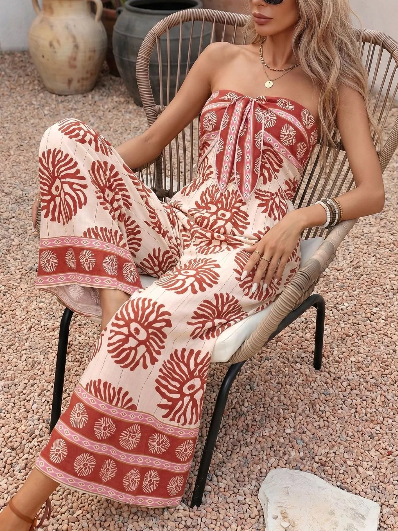 Trendsi floral print strapless wide-leg jumpsuit in mahogany color, featuring a stylish one-piece design and flowing silhouette.