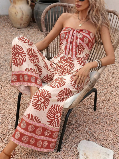Trendsi floral print strapless wide-leg jumpsuit in mahogany color, featuring a stylish one-piece design and flowing silhouette.
