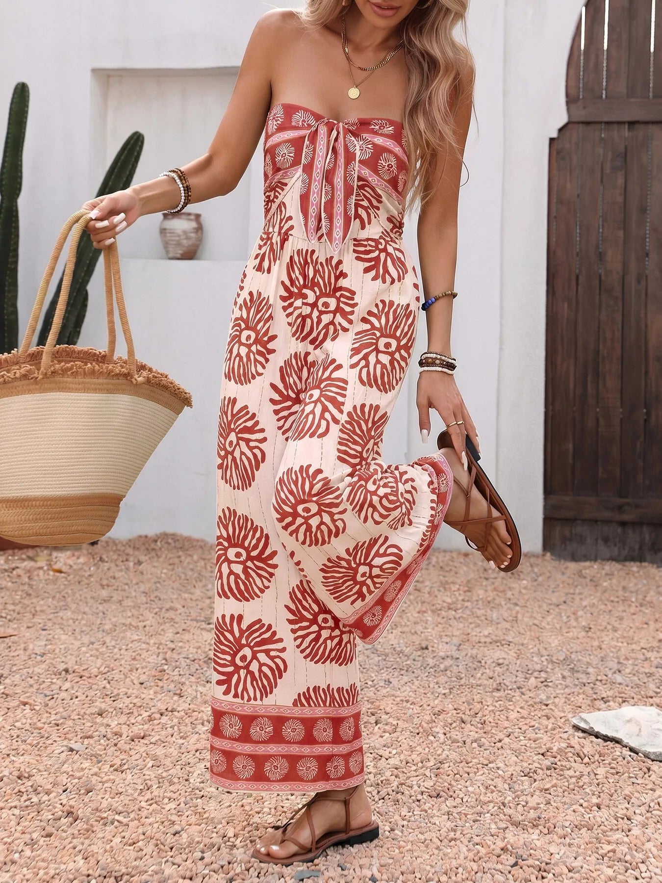 Trendsi floral print strapless wide-leg jumpsuit in mahogany color, showcasing its one-piece design and flowing silhouette.