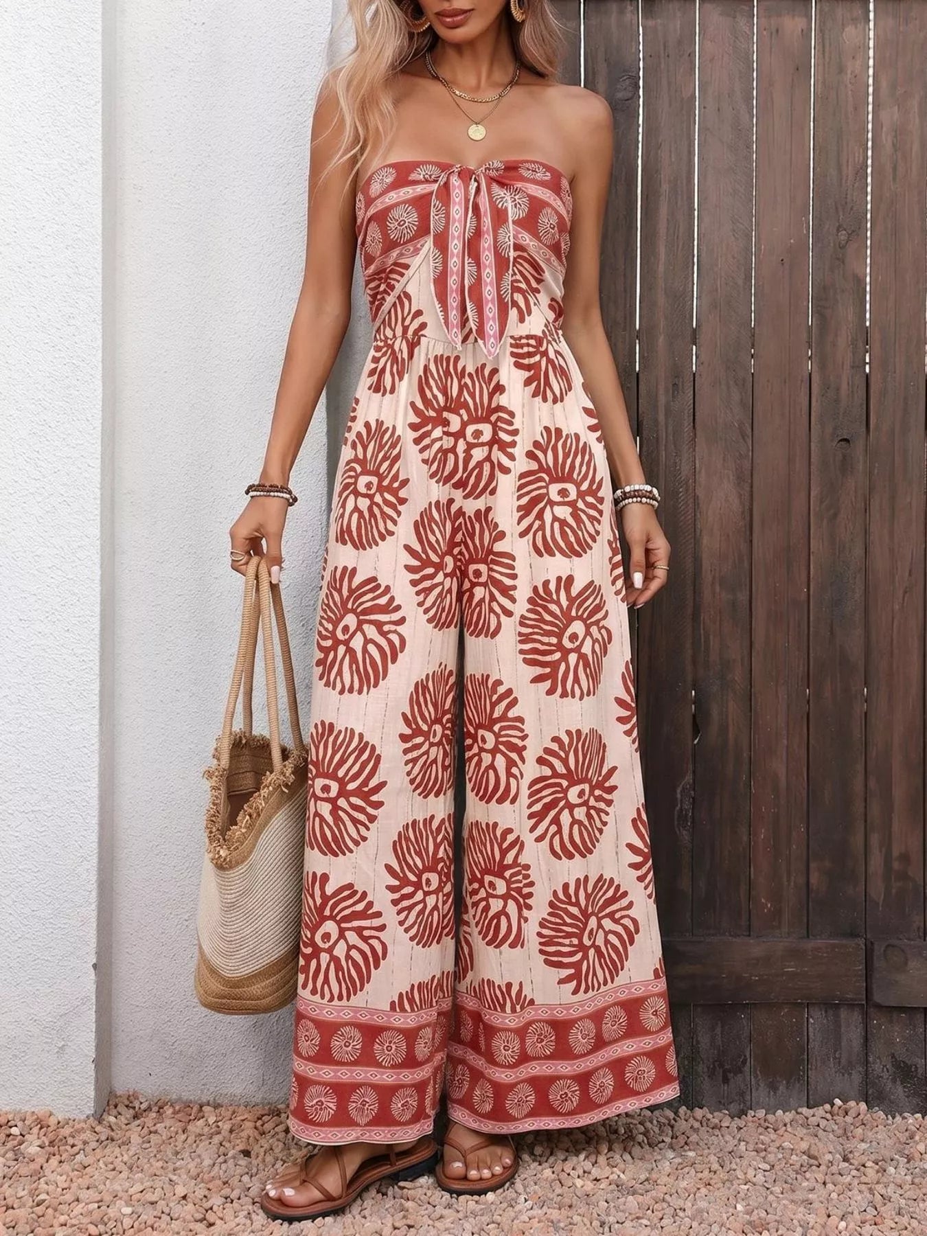 Trendsi floral print strapless wide-leg jumpsuit in mahogany color, featuring a stylish one-piece design and relaxed fit.