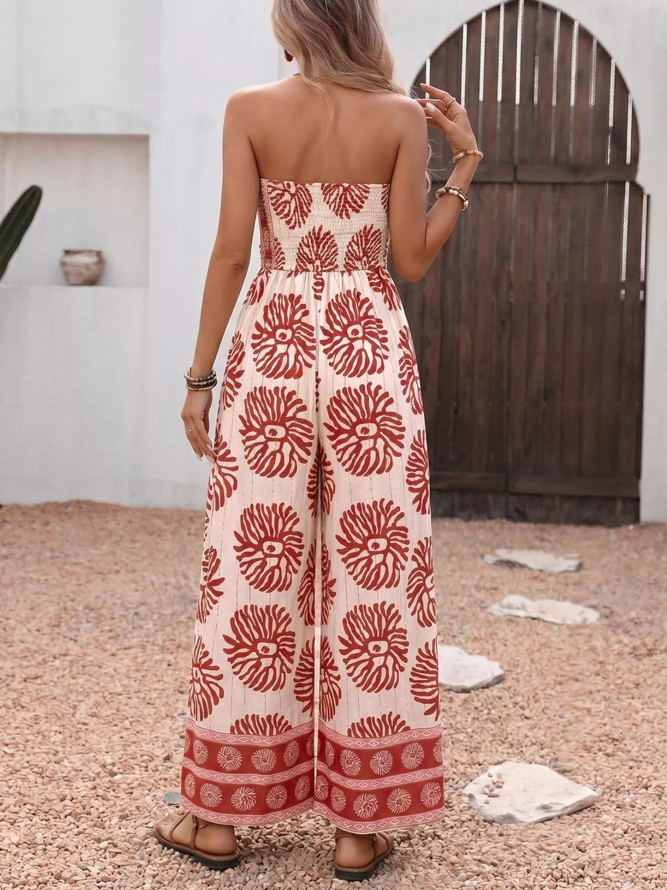 Trendsi floral print strapless wide-leg jumpsuit in mahogany color, featuring a one-piece design and flowy silhouette.