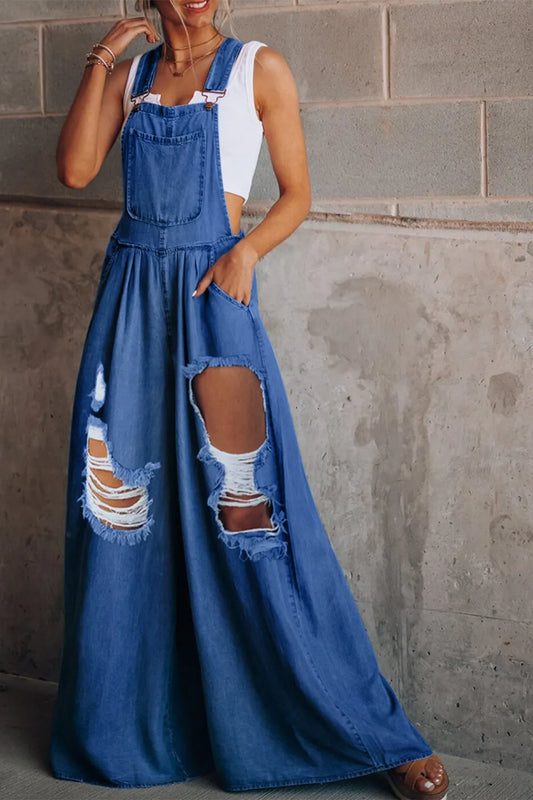 Distressed wide-leg denim overalls by Trendsi, featuring a relaxed fit, adjustable straps, and a fashionable casual style.