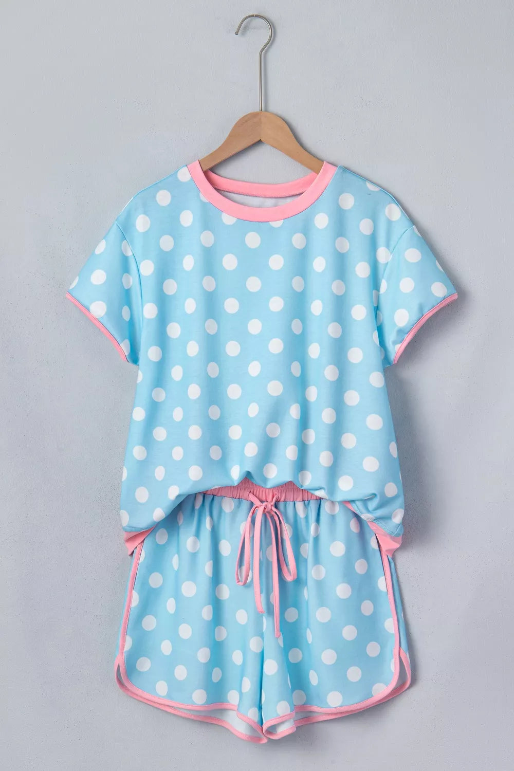Pastel blue polka dot contrast trim top and drawstring shorts set by Trendsi, casual loungewear with playful pattern.