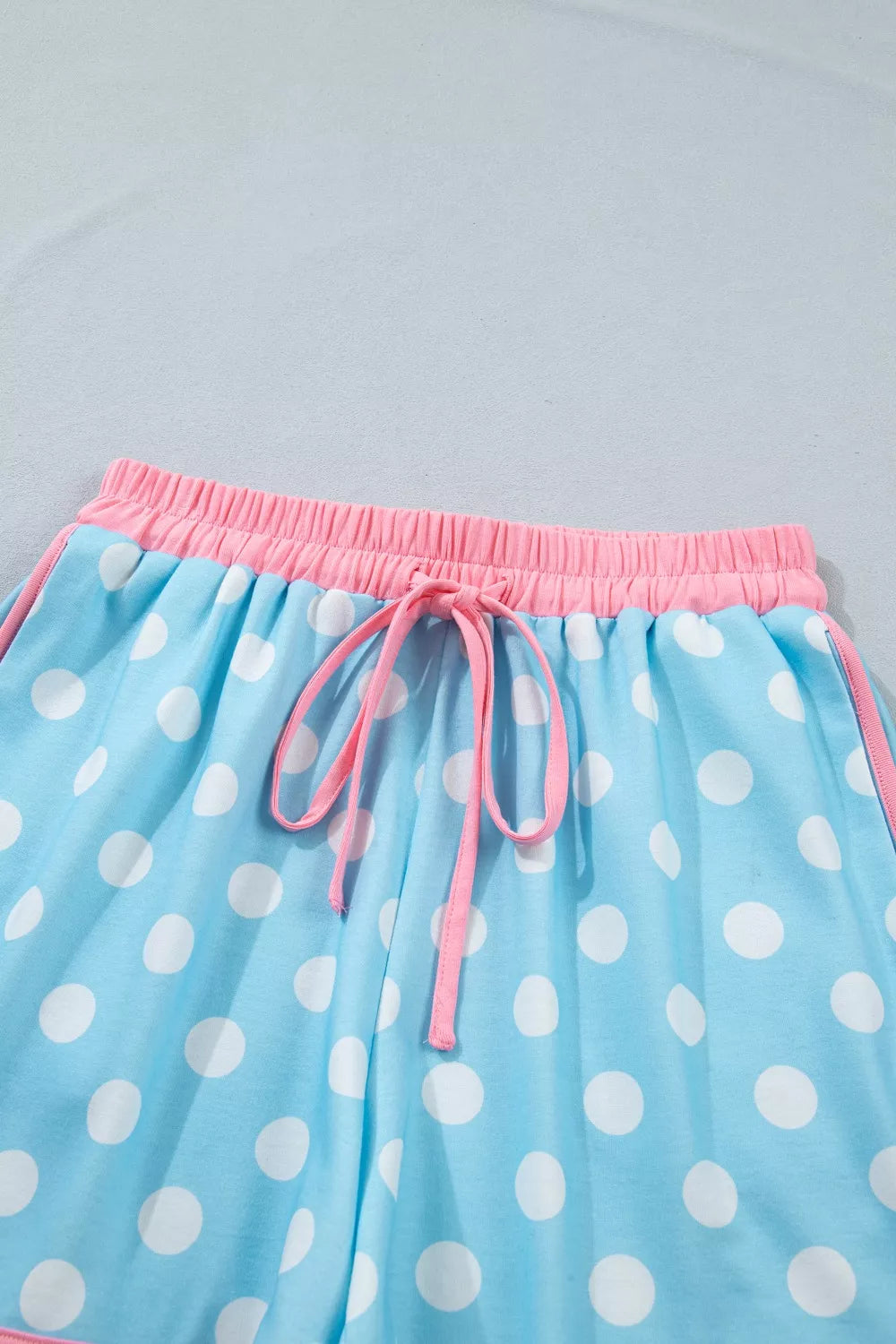 Pastel blue polka dot contrast trim top and drawstring shorts set by Trendsi, casual summer outfit with comfortable fit.