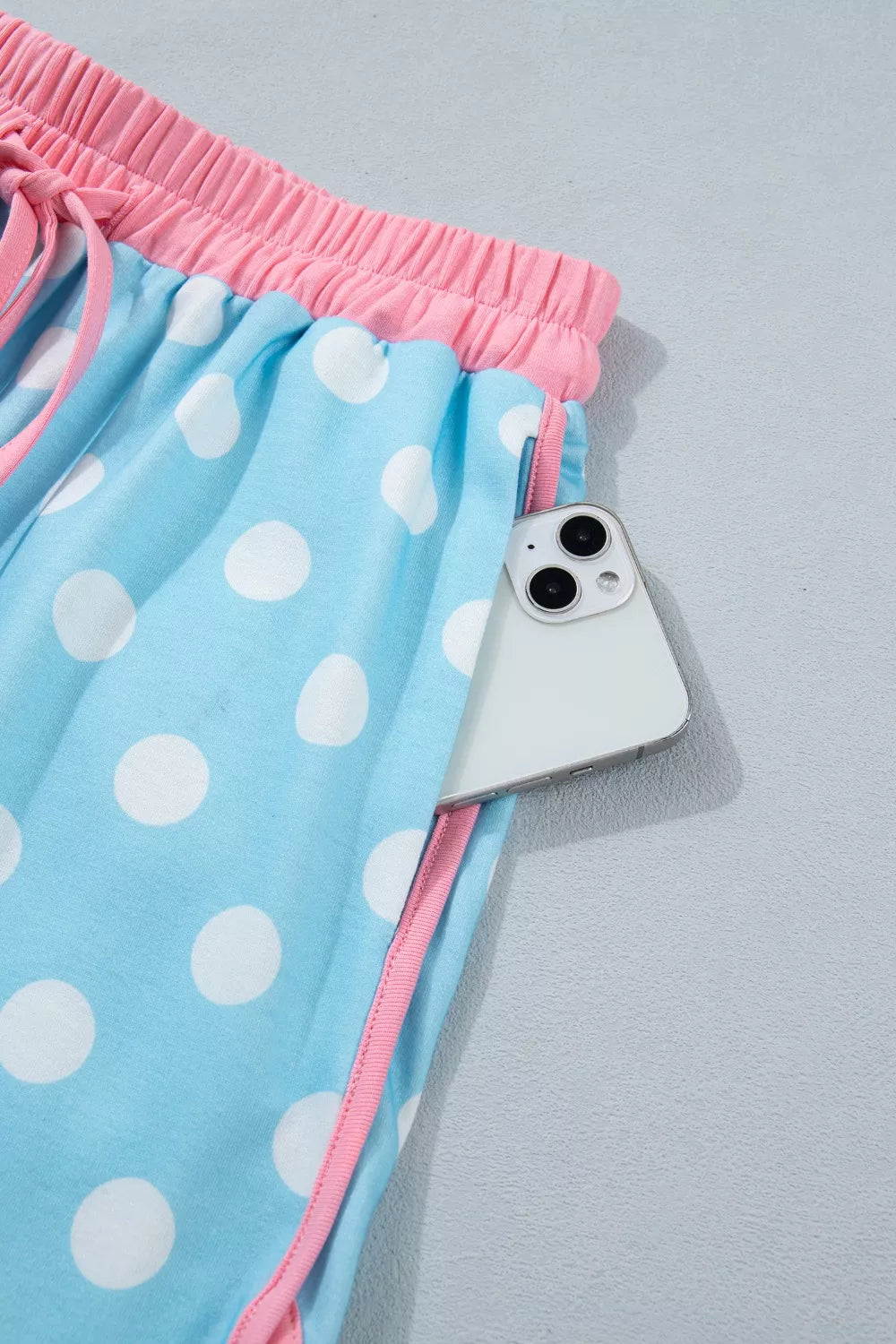 Pastel blue polka dot contrast trim top and drawstring shorts set from Trendsi, casual and comfortable summer outfit.
