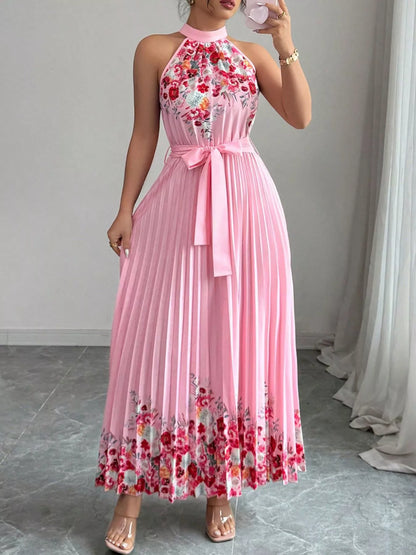 Pink floral print halter neck maxi dress with pleated design by Trendsi, featuring a flowing, elegant style.