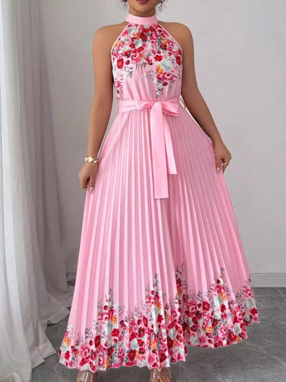 Pink halter neck floral print pleated maxi dress from Trendsi, flowing fabric and elegant design for summer occasions.