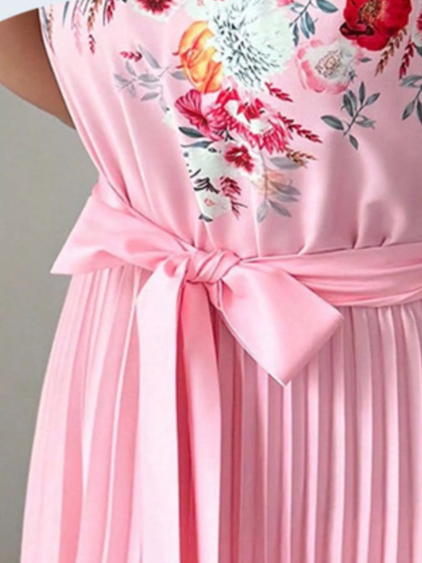 Pink halter neck floral print pleated maxi dress by Trendsi, featuring a flowing silhouette and elegant design.