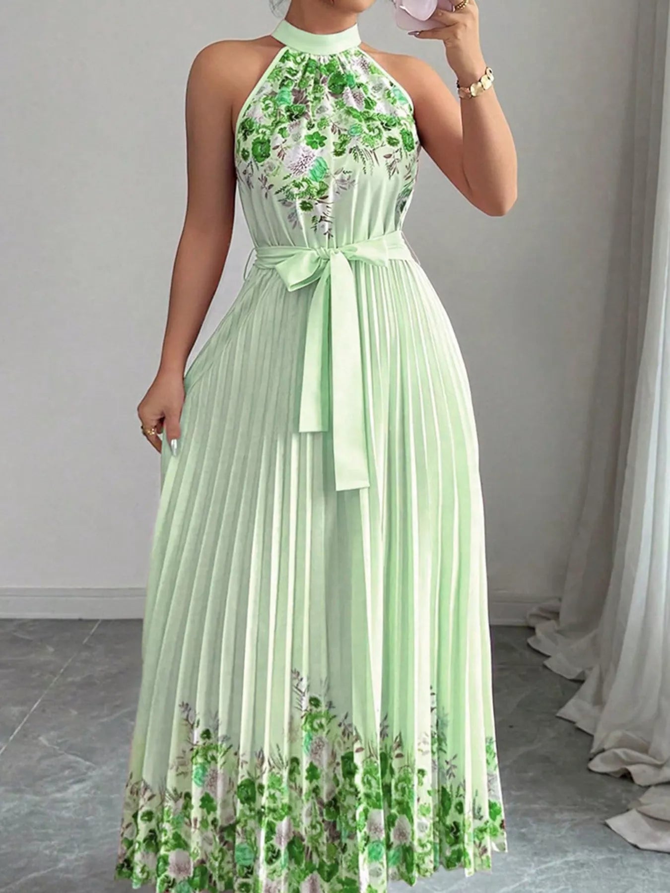 Pink floral print halter neck maxi dress with pleated design, by Trendsi, shown laid flat highlighting the elegant style.