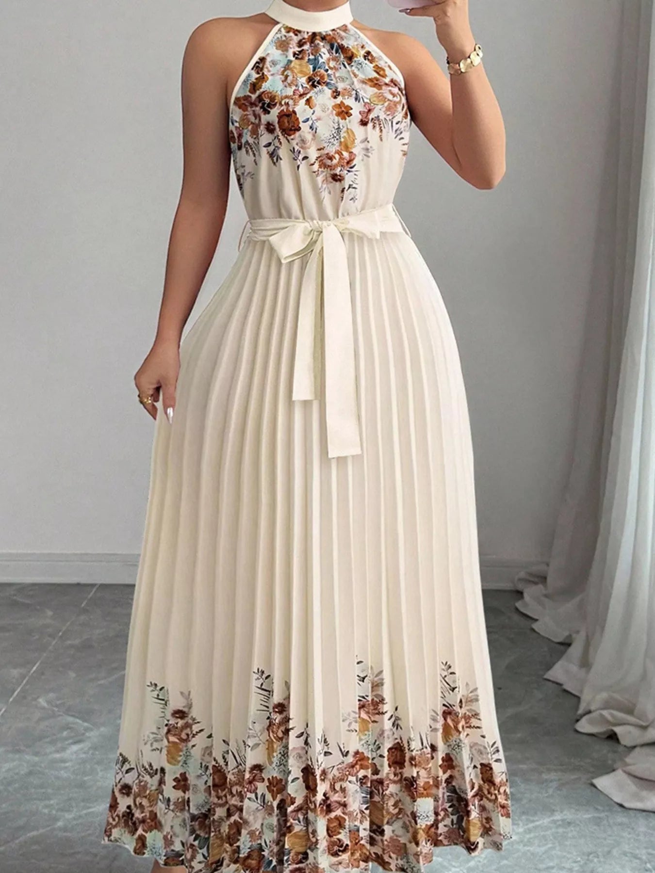 Pink floral print halter neck pleated maxi dress by Trendsi, flowing fabric with a stylish halter neckline and elegant pleats.