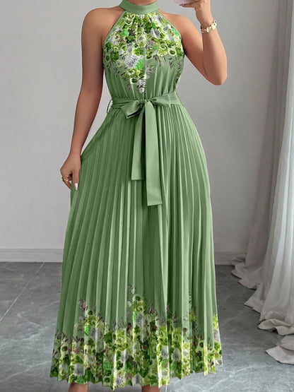 Pink halter neck floral print pleated maxi dress from Trendsi, flowing fabric with a stylish, elegant design for warm-weather occasions.