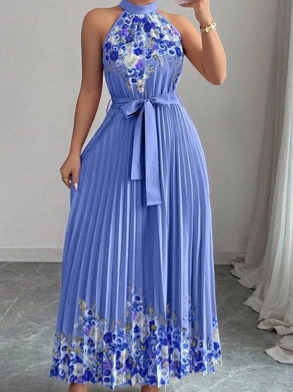 Pink halter neck floral print pleated maxi dress by Trendsi, flowing design with a vibrant floral pattern and elegant silhouette.