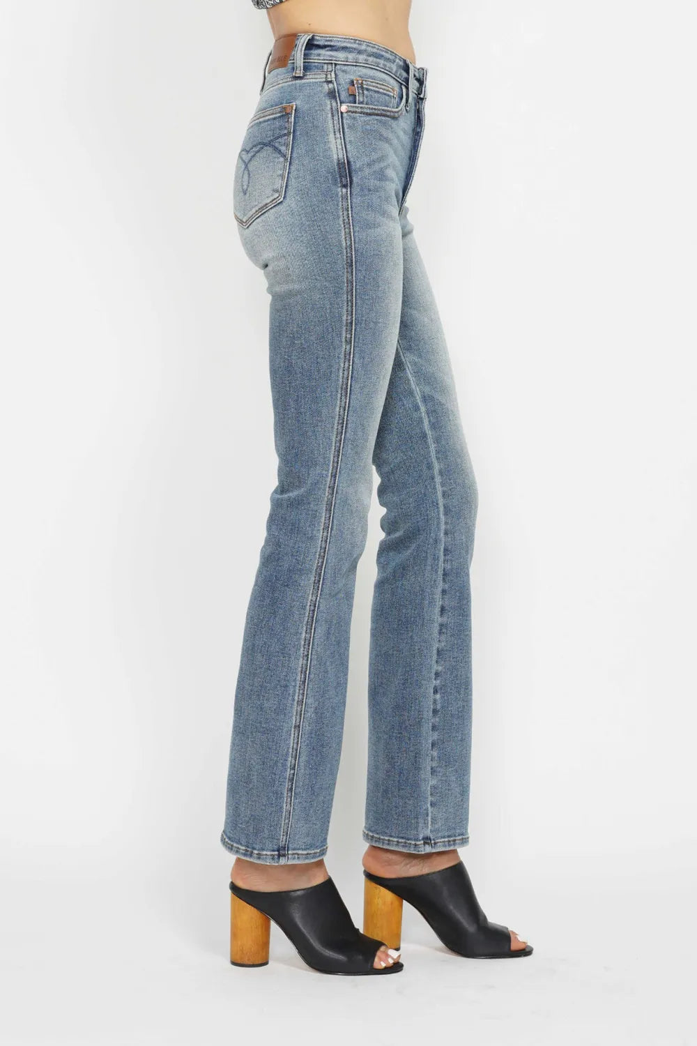 Judy Blue plus size bootcut jeans with tummy control, back embroidery, and pocket details, designed for a flattering fit.