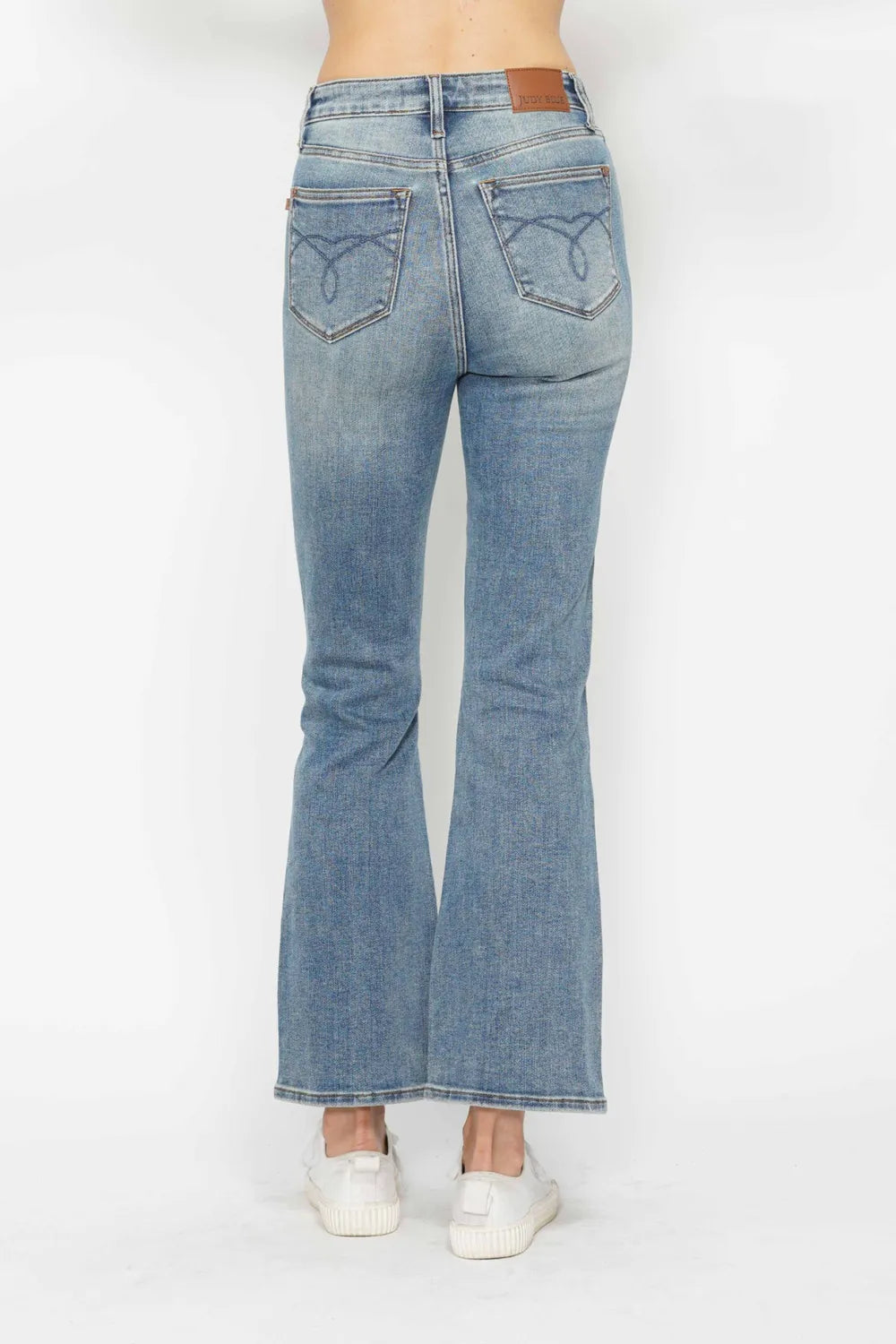 Plus size Judy Blue bootcut jeans with tummy control, embroidered pockets, and back pockets, designed for a comfortable fit.