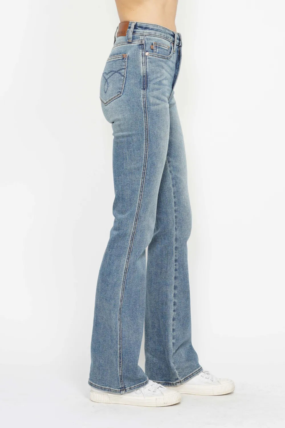 Plus size Judy Blue bootcut jeans with tummy control, embroidered pockets, and back pockets, designed for a comfortable fit.