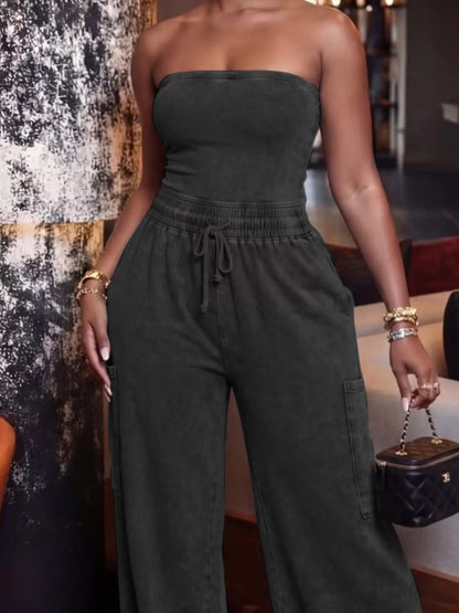 Black strapless wide-leg jumpsuit with drawstring waist from Trendsi, shown on a model with a sleek, modern design.