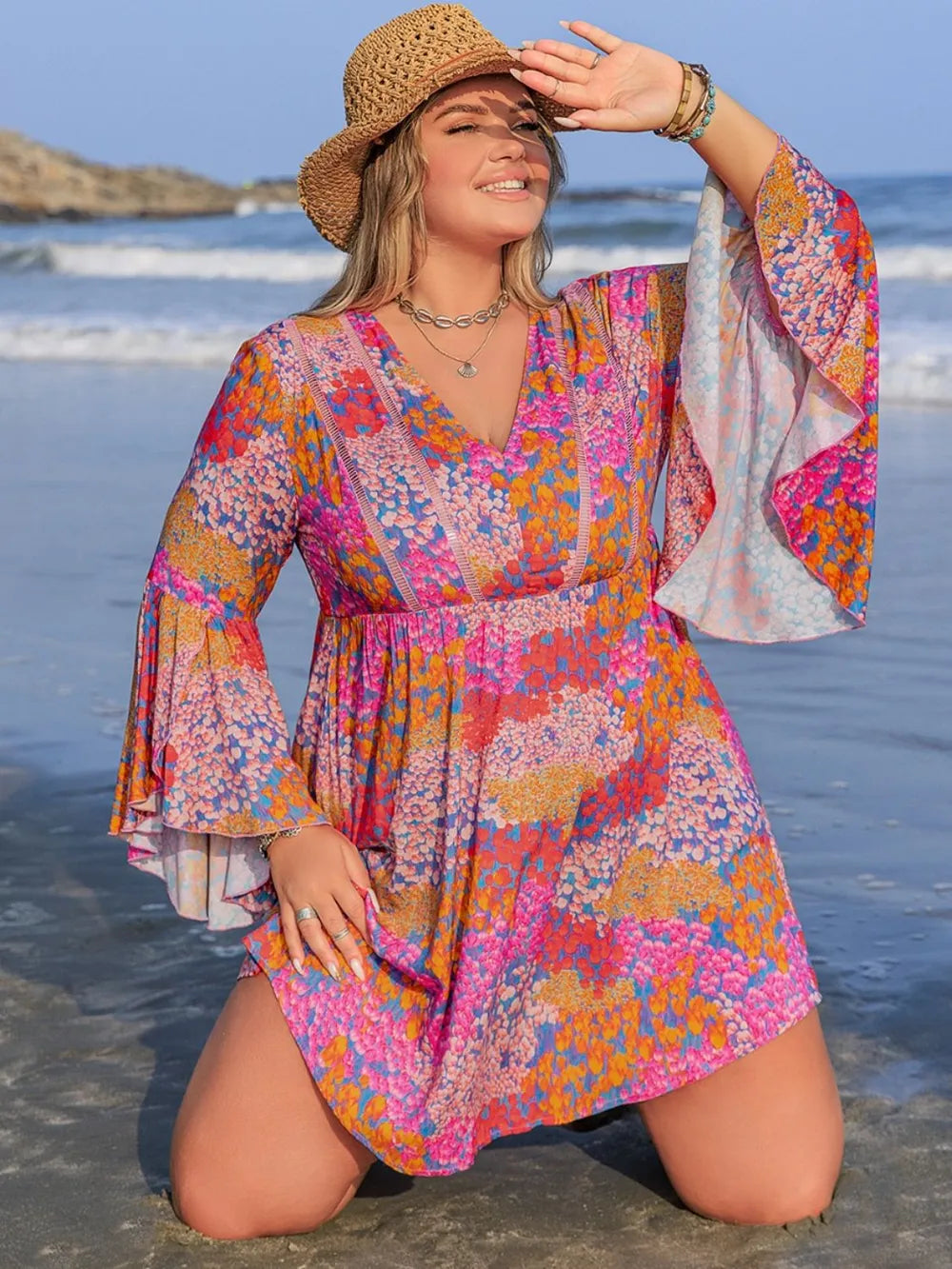 Plus size ruched long sleeve dress by Trendsi featuring a chic, elegant design with a fitted silhouette and stylish details.