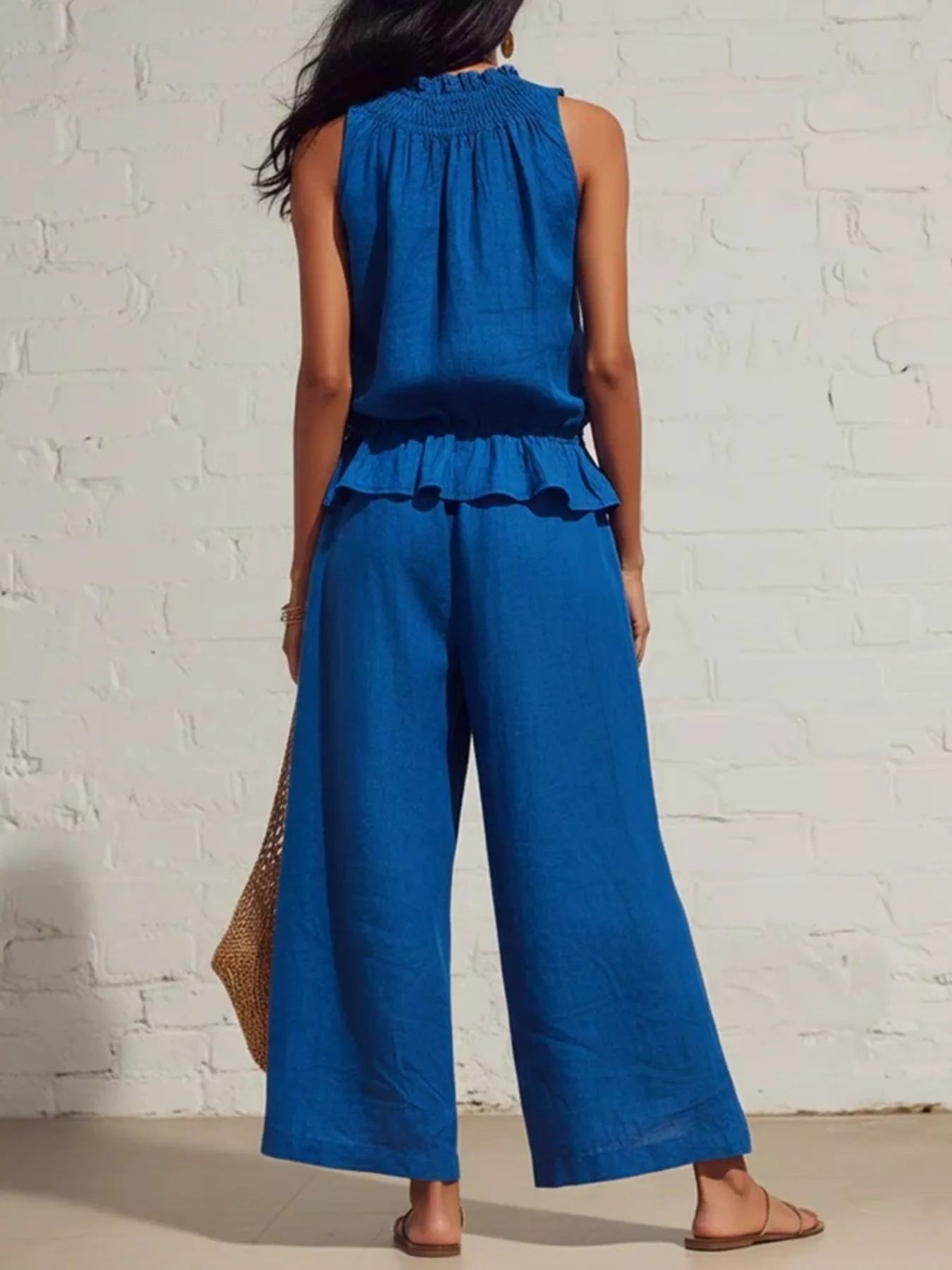 Smocked ruffled hem top and wide-leg pants set by Trendsi, featuring a stylish, coordinated fashion ensemble in soft fabric.