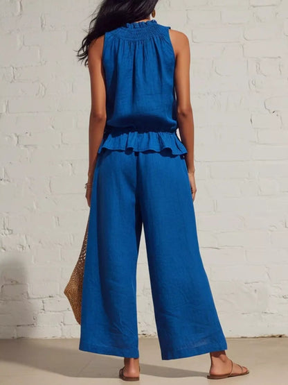 Smocked ruffled hem top and wide-leg pants set by Trendsi, featuring a stylish, coordinated fashion ensemble in soft fabric.