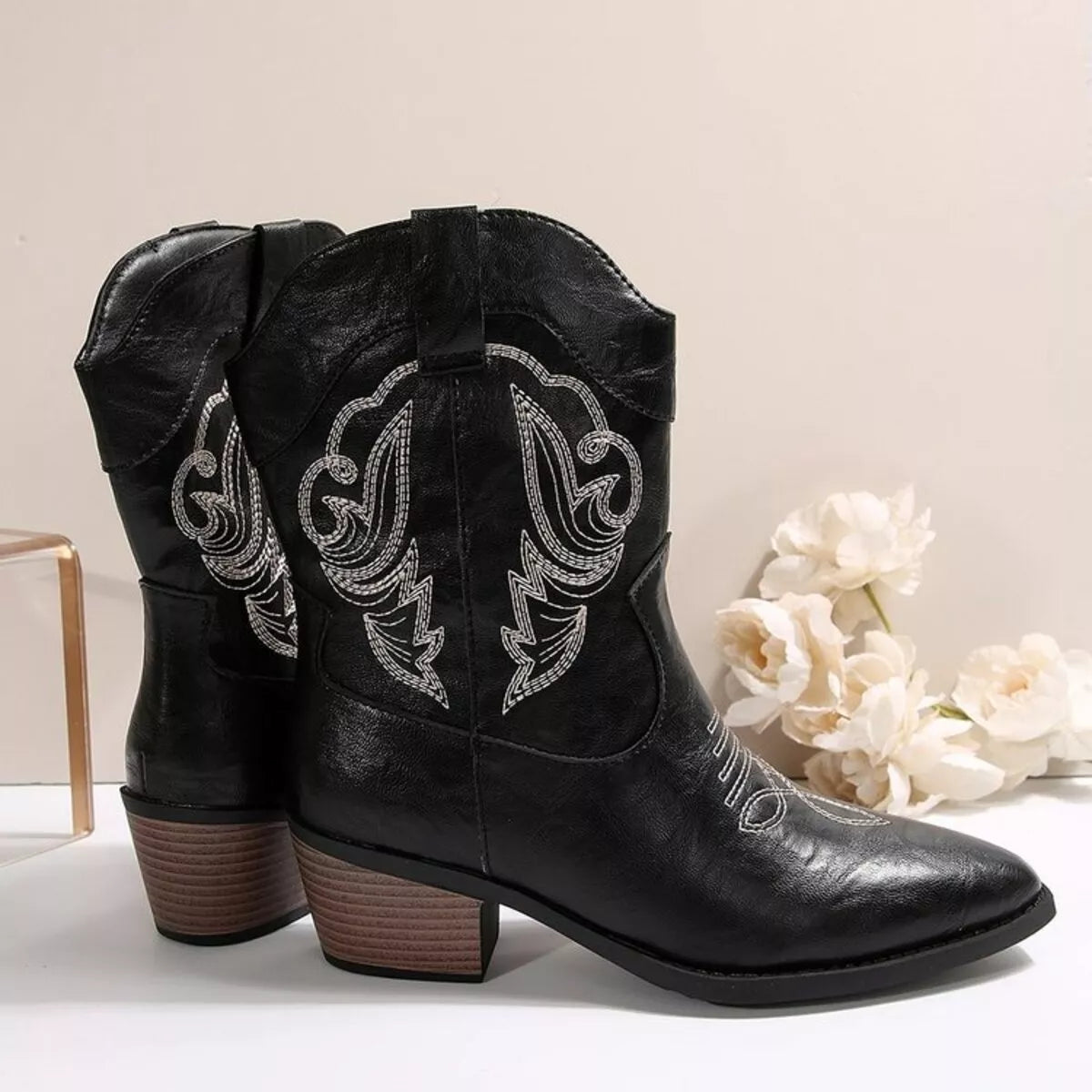 Black Western cowboy boots with embroidered design, trendy shoes by Trendsi, showcasing detailed floral embroidery and classic Western style.