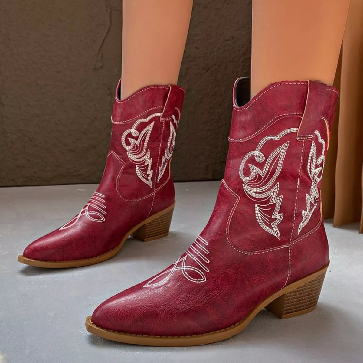 Black Western cowboy boots with intricate embroidered design, trendy shoes by Trendsi featuring classic Western style.