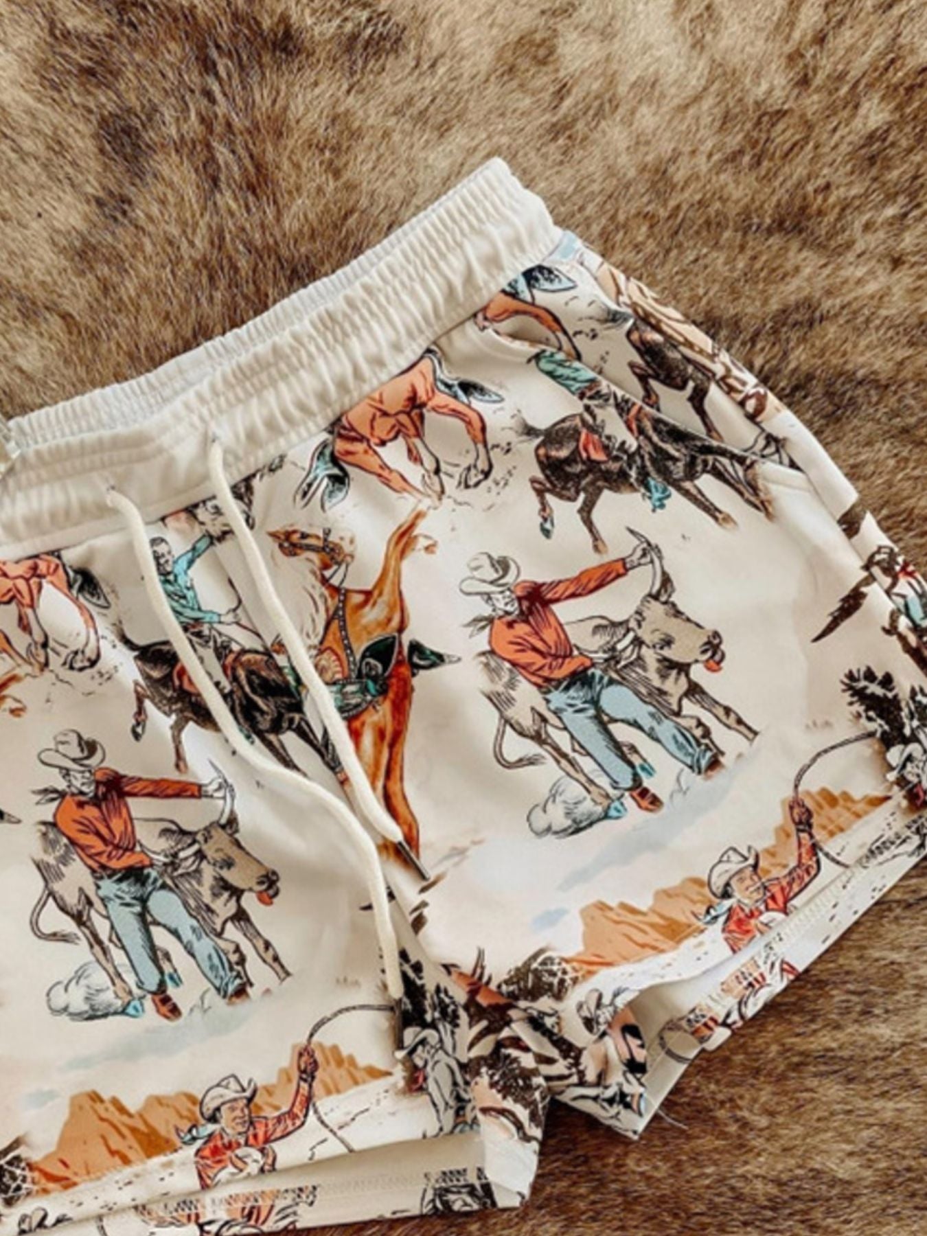 Wild West Rodeo print drawstring shorts from Trendsi, featuring colorful cowboy-themed design and comfortable fit.