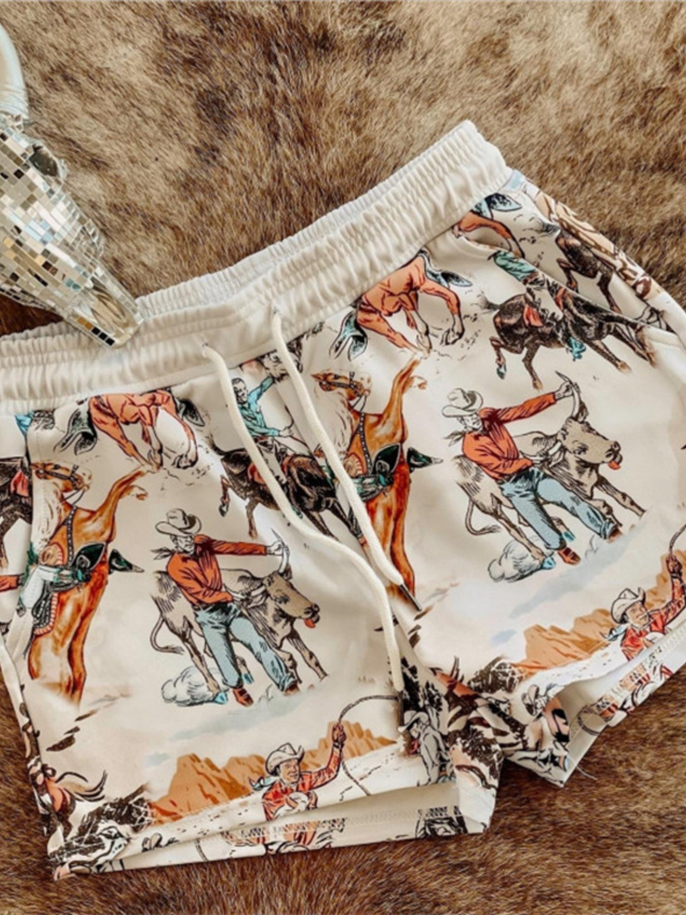 Wild West Rodeo print drawstring shorts by Trendsi featuring a cowboy-themed rodeo design and lightweight casual style.