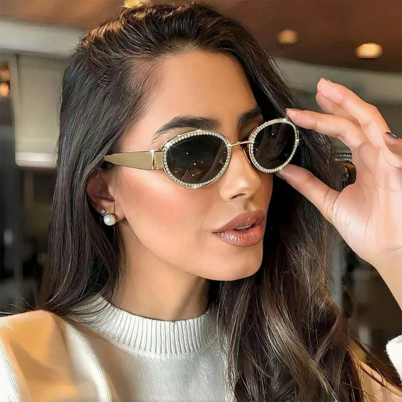 Oval sunglasses with rhinestone embellishments from Trendsi, featuring a stylish frame and sparkling decorative details.