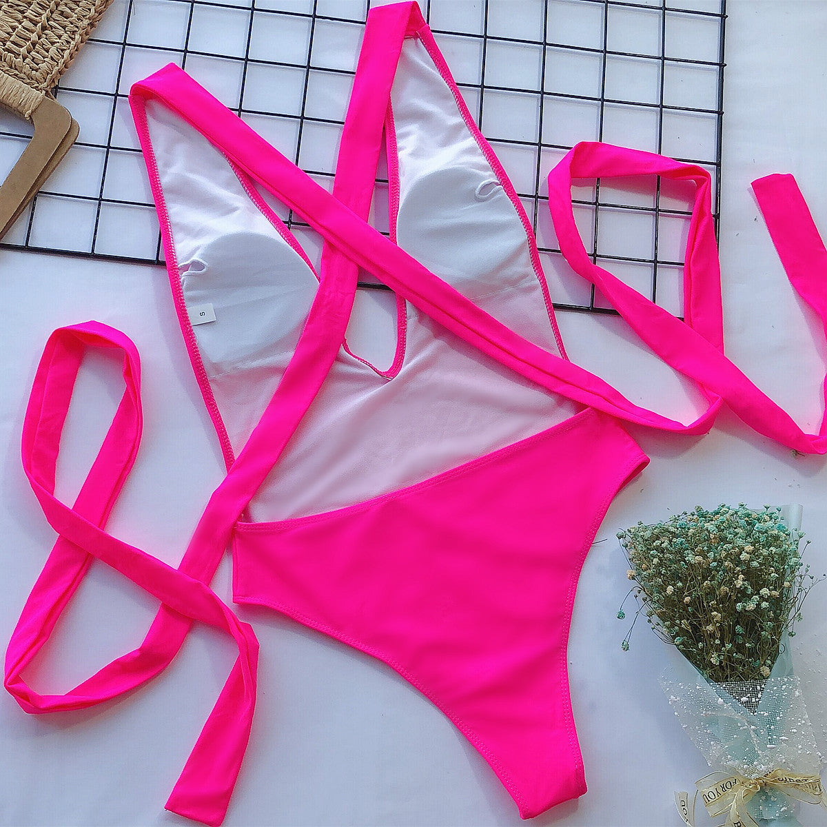 Hot pink halter neck deep V tied one-piece swimsuit by Trendsi, showcasing stylish swimwear with a flattering fit.