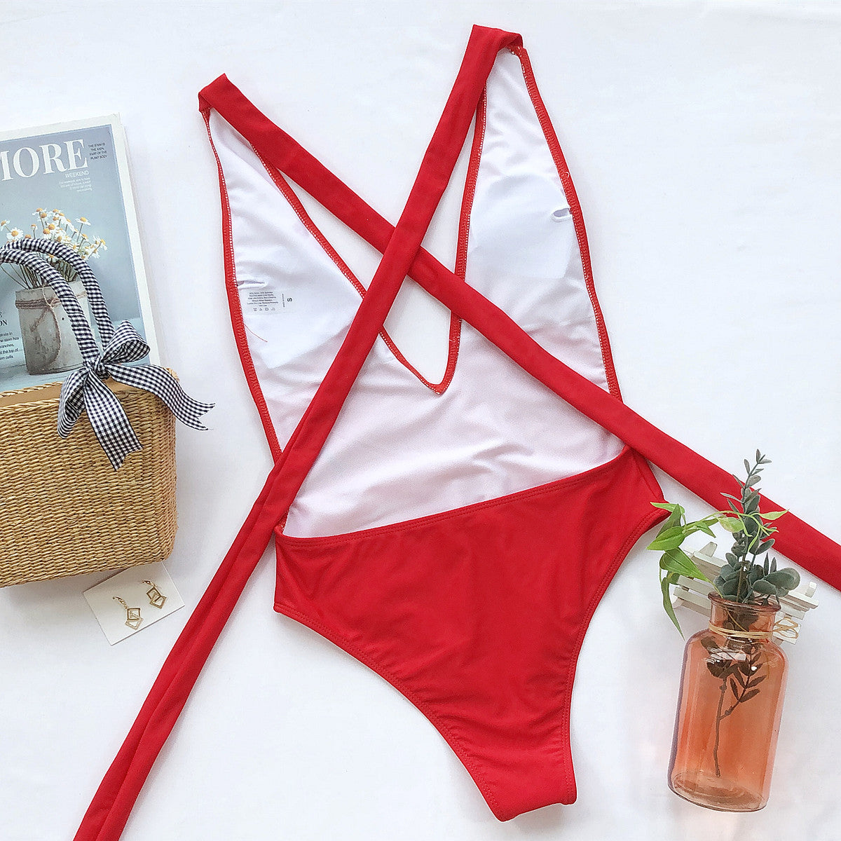 Hot pink halter neck deep V one-piece swimsuit from Trendsi, featuring a tied front design and stylish swimwear appeal.