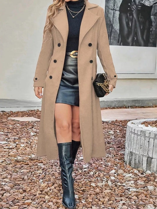 Plus size tan double-breasted longline trench coat by Trendsi, featuring a stylish, full-length design with wide lapels and belt.