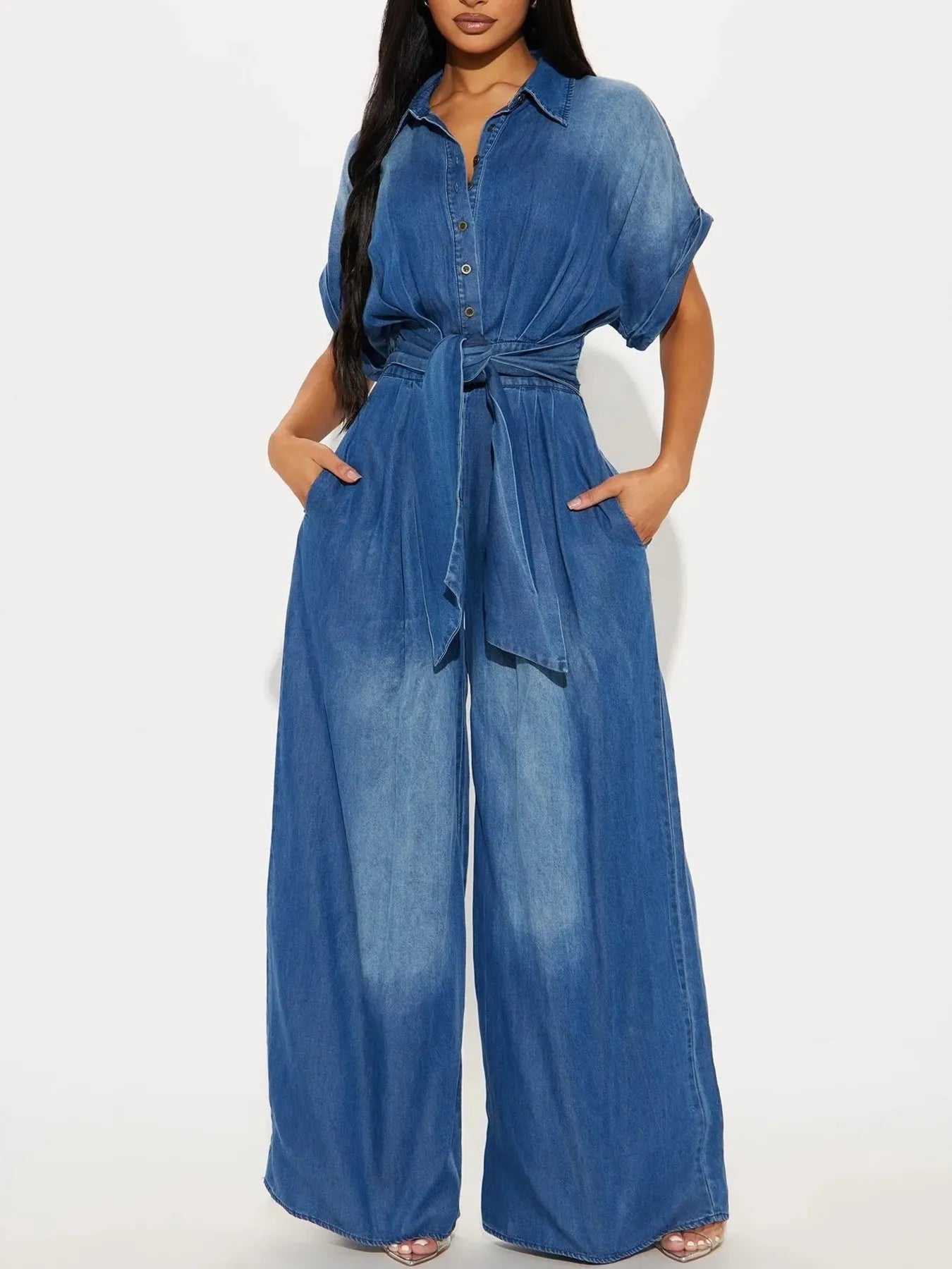 Vintage blue button-front wide-leg denim jumpsuit by Trendsi, featuring classic style and relaxed fit.