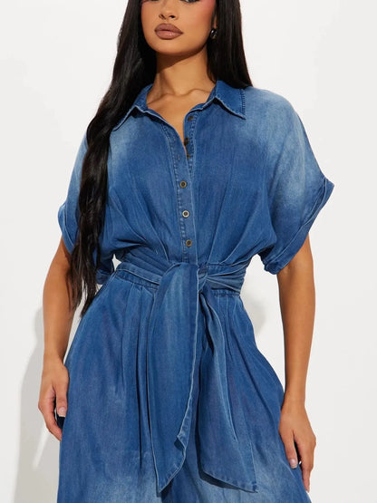 Vintage blue button-front wide-leg denim jumpsuit by Trendsi, featuring a relaxed fit and stylish design.