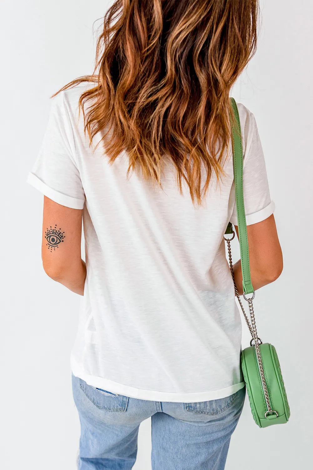 White graphic round neck T-shirt by Trendsi, featuring a stylish design for everyday casual wear.