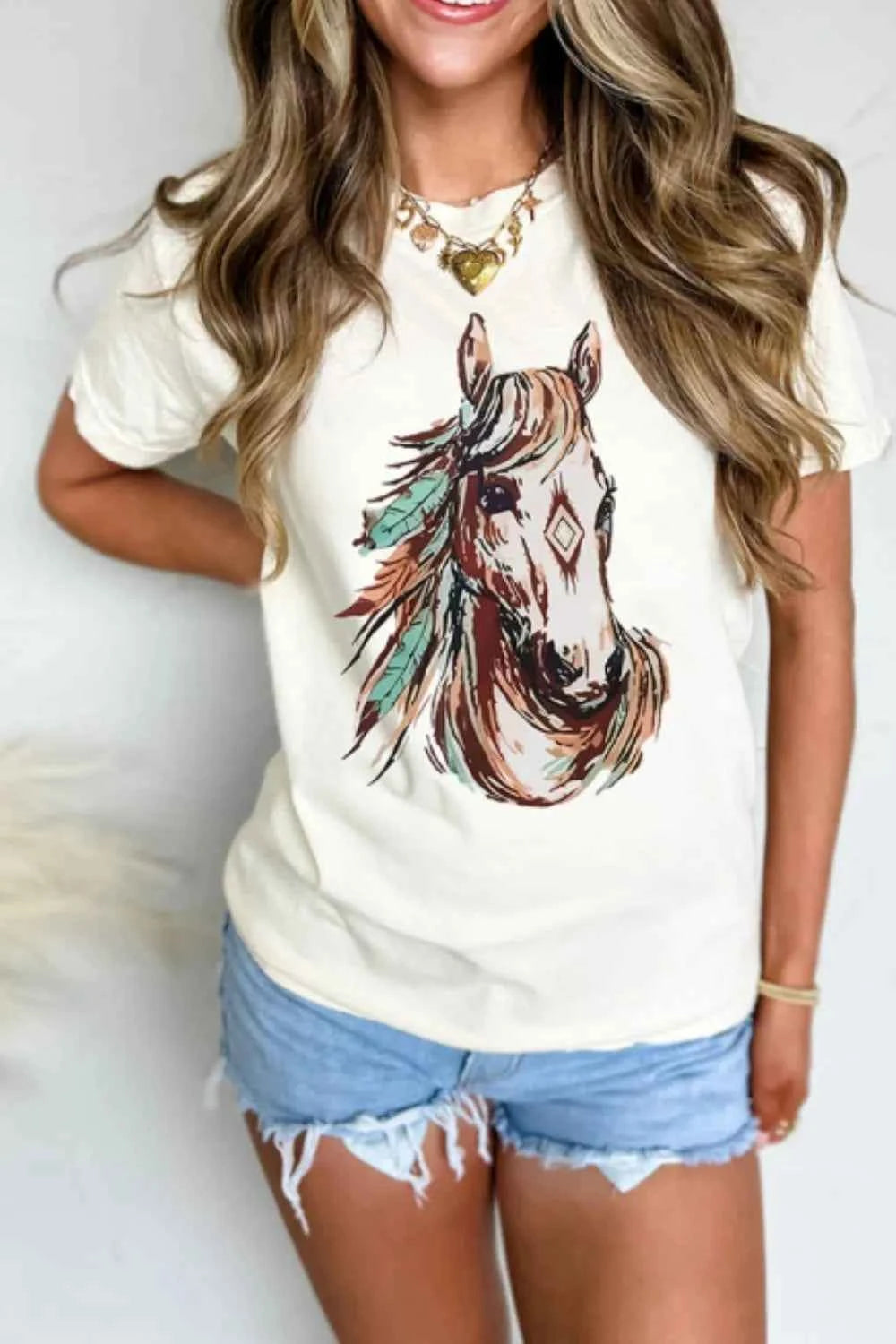 White Western Aztec Horse Graphic Tee by Trendsi featuring a stylish horse and geometric Aztec design on soft cotton fabric.