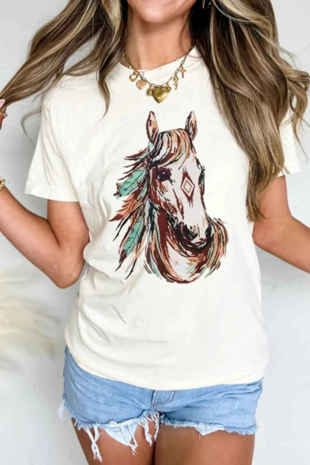 White Western Aztec horse graphic T-shirt by Trendsi featuring a stylish horse and Aztec design, casual and trendy for everyday wear.