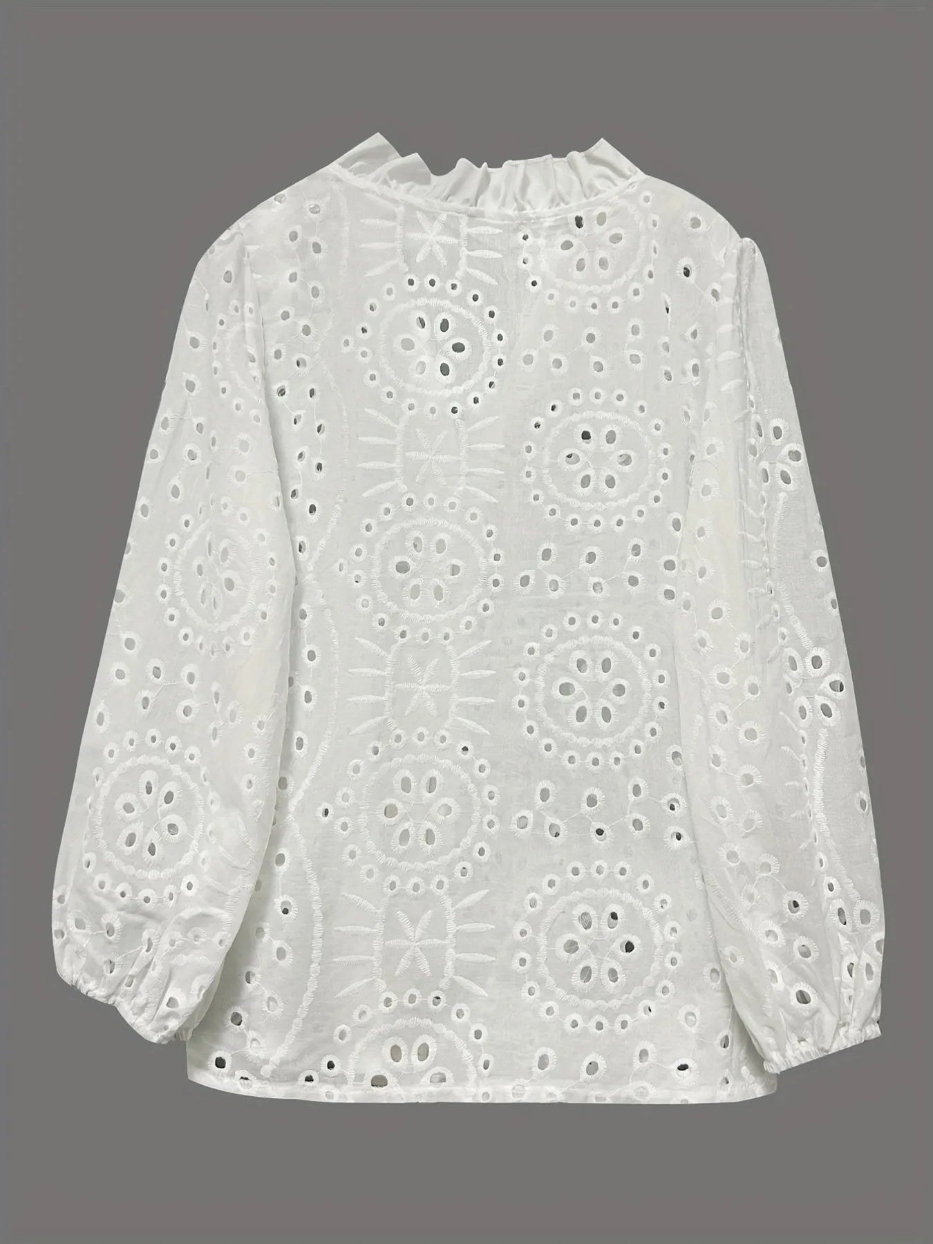Eyelet embroidered button-front shirt with puffed sleeves, stylish and feminine, featuring intricate embroidery and a classic fit.